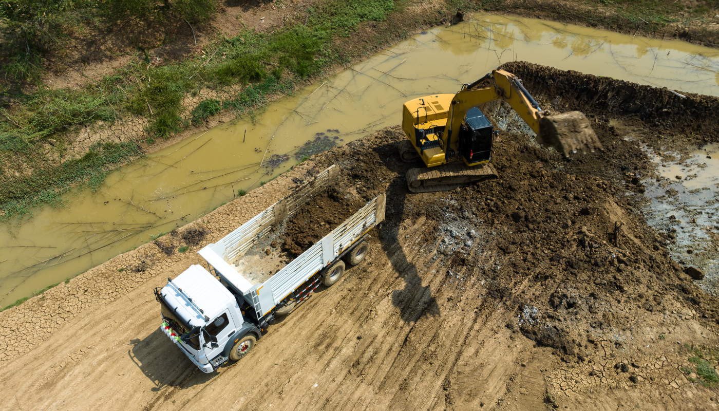 A white truck driving down a muddy road