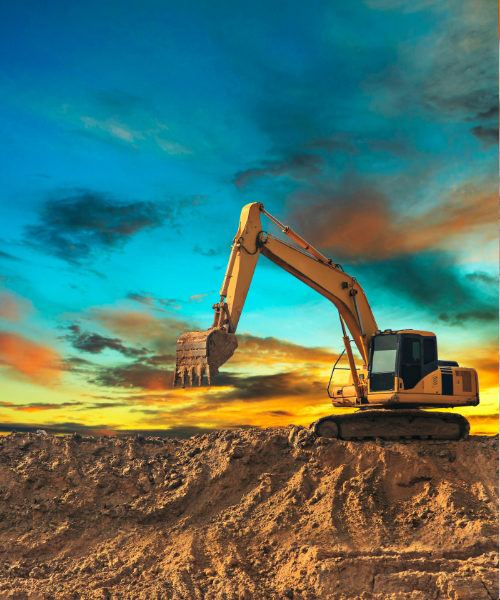 A large excavator sitting on top of a pile of dirt