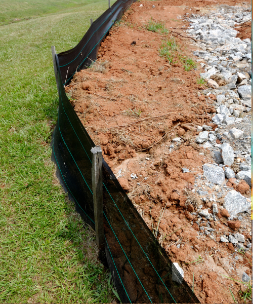 A section of a fence that has been dug into the ground