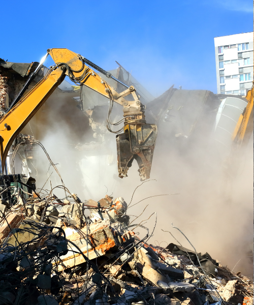 A bulldozer digging through a pile of rubble