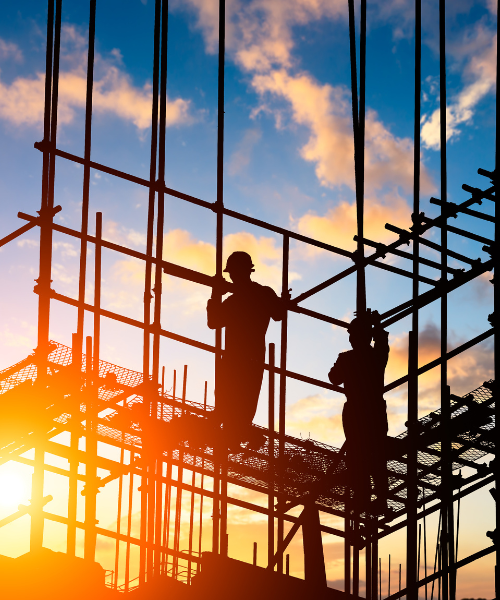 A couple of men standing on top of a scaffolding